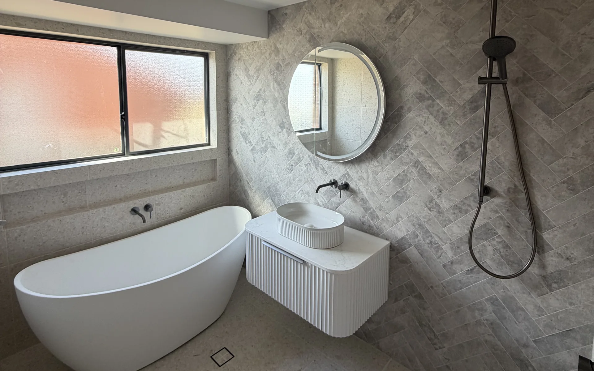 Renovated bathroom in Dubbo with a freestanding bath, wall hung vanity and tiled shower