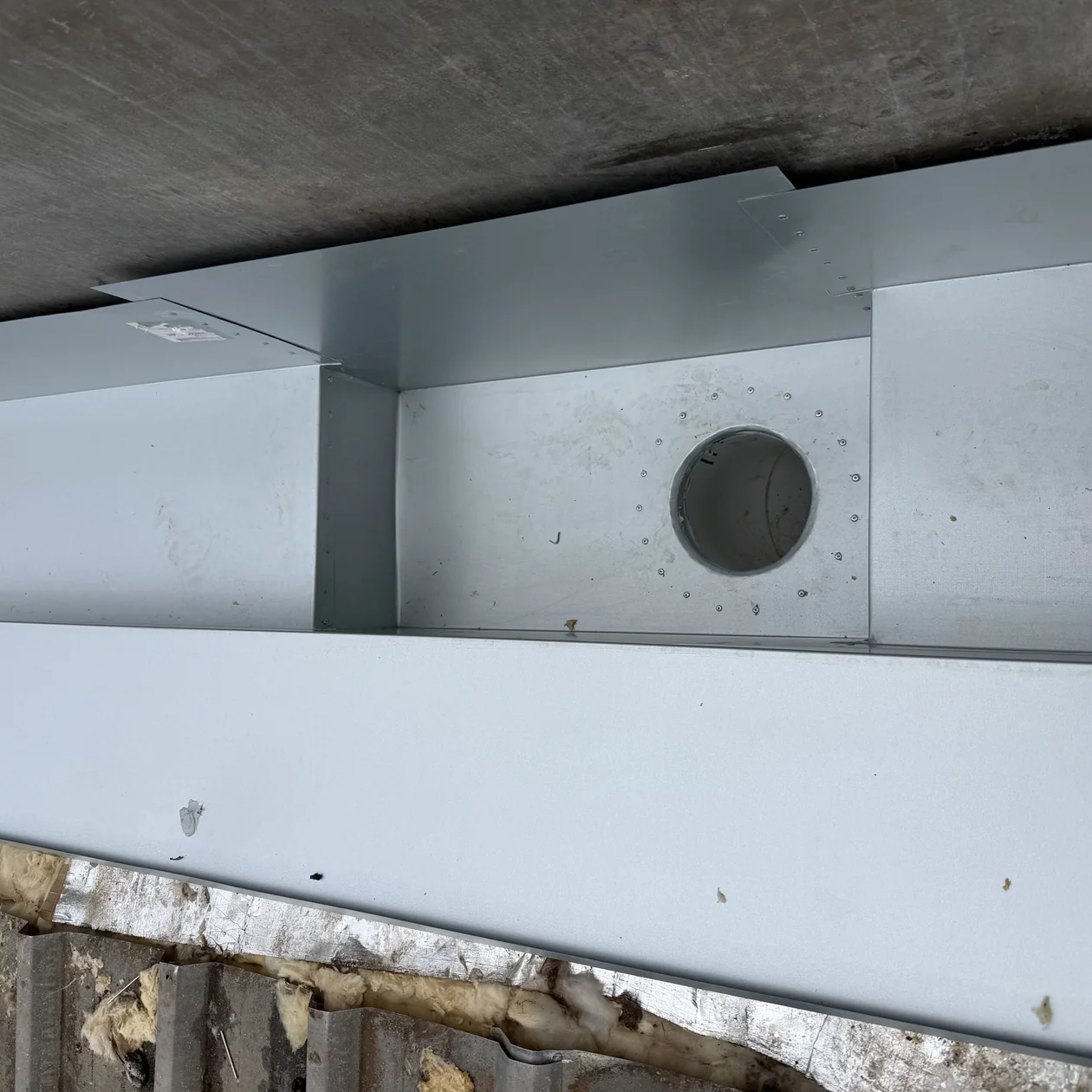 Box gutter and sump outlet detail on a metal roof
