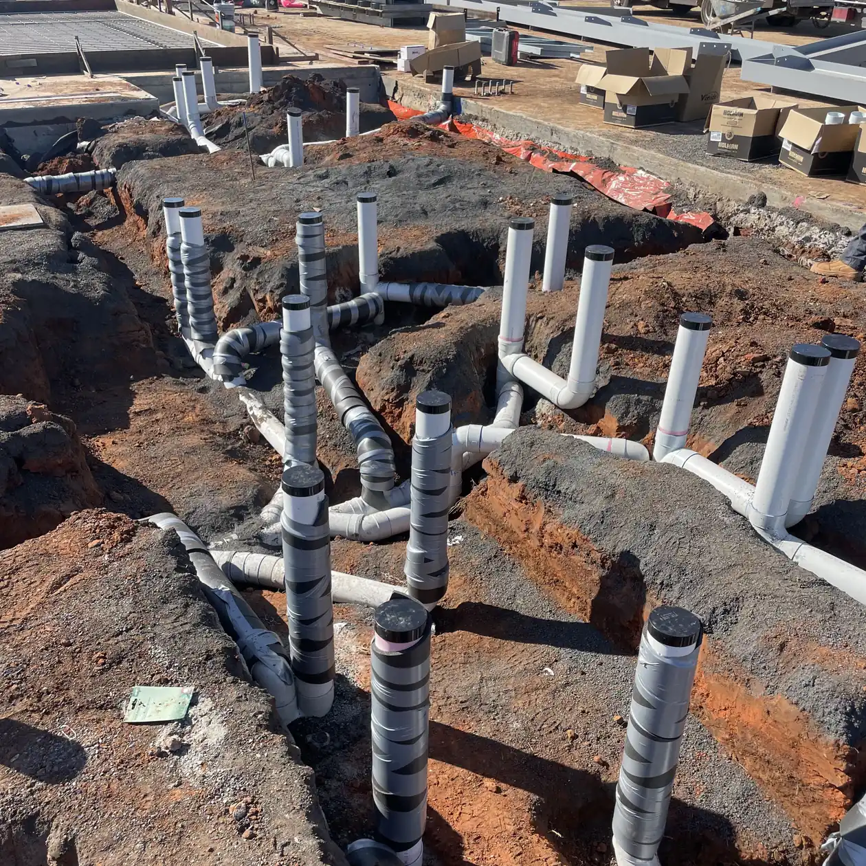 Lagged pipework and services roughed in on a commercial construction site