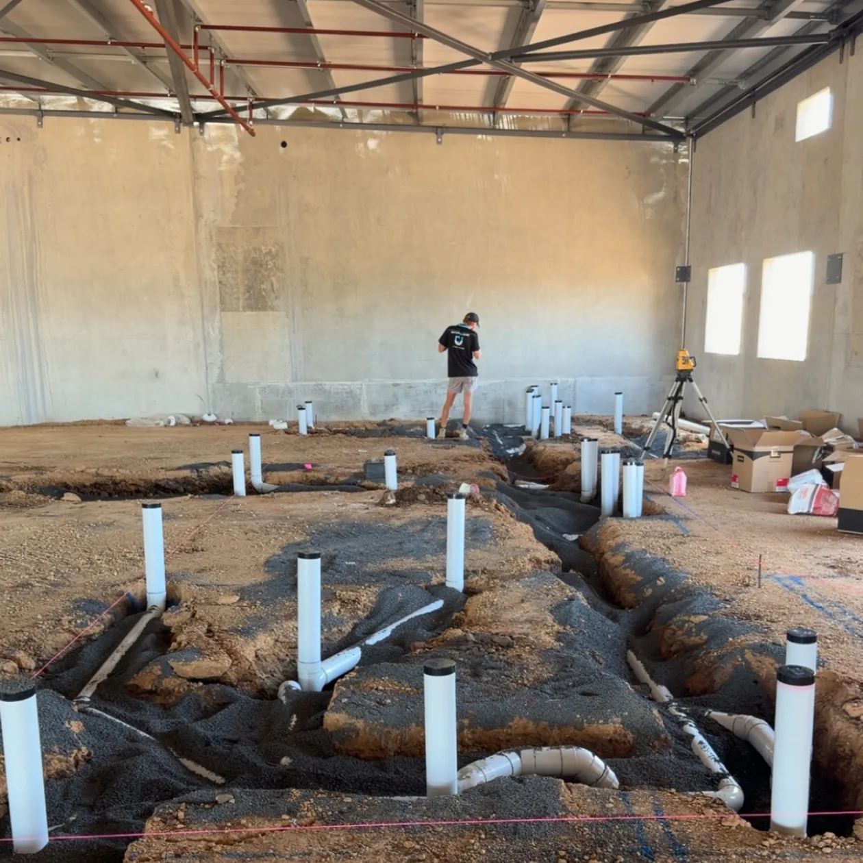 In-slab sanitary drainage laid out before the concrete pour