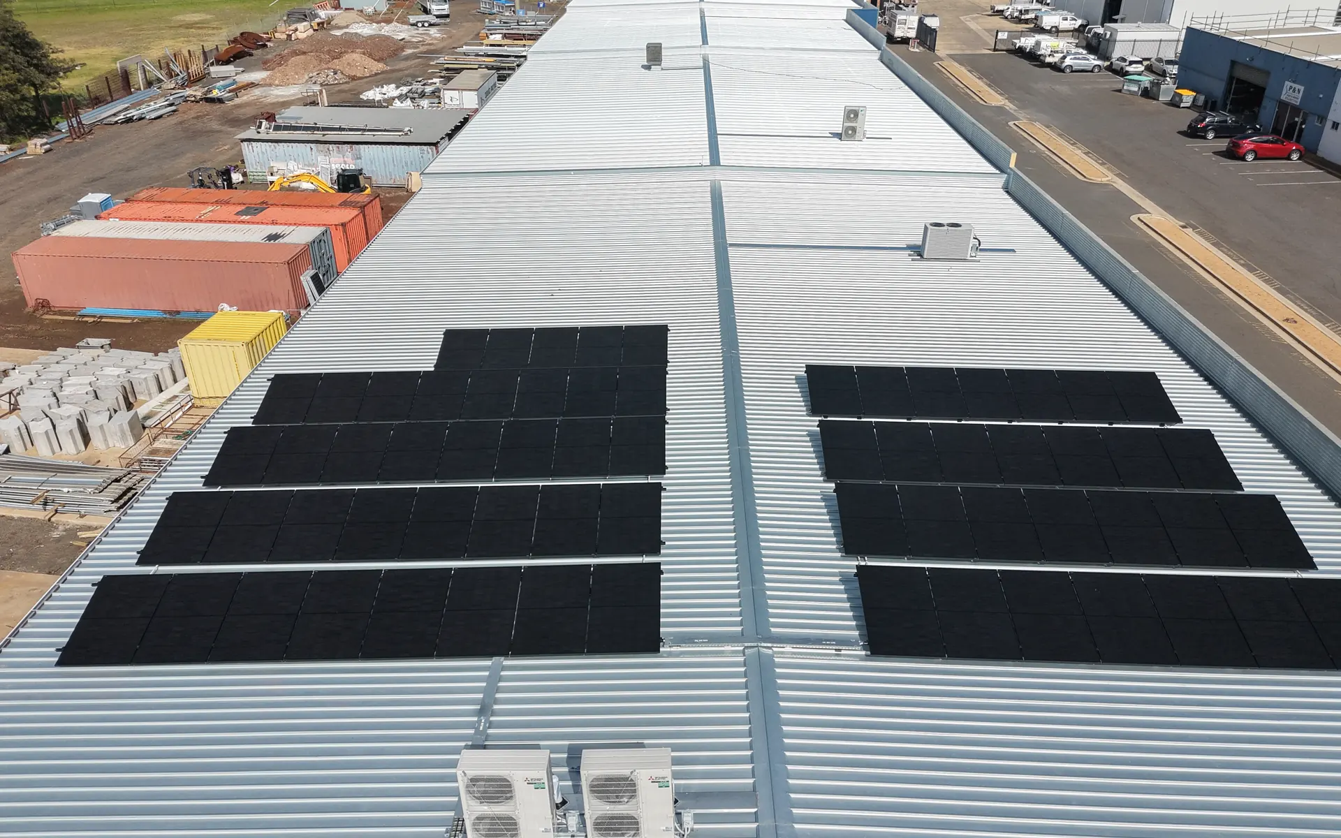 Aerial view of a large metal roof on a commercial building