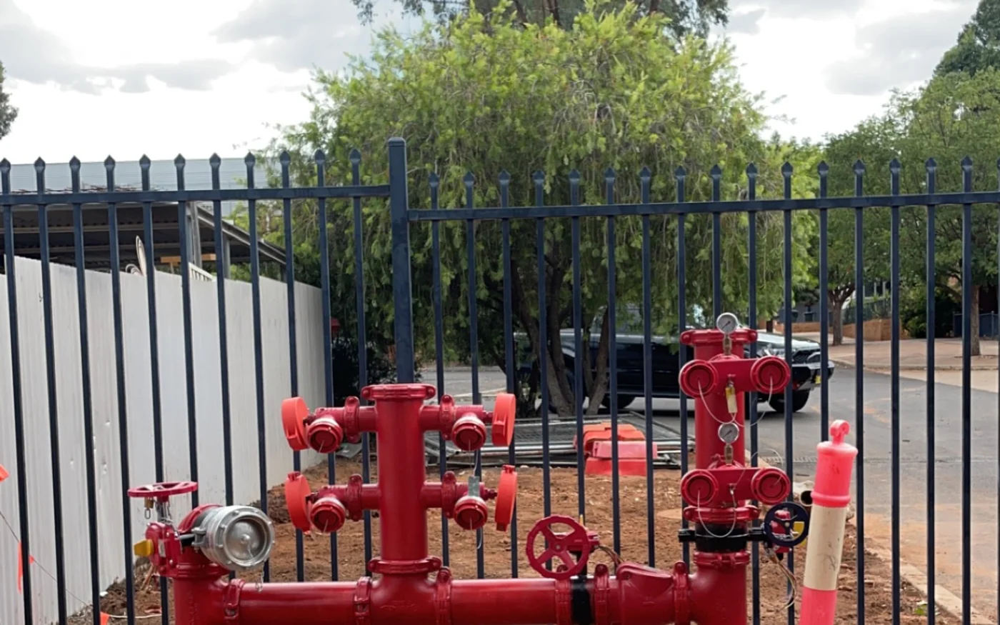 Fire hydrant booster assembly installed at a commercial property