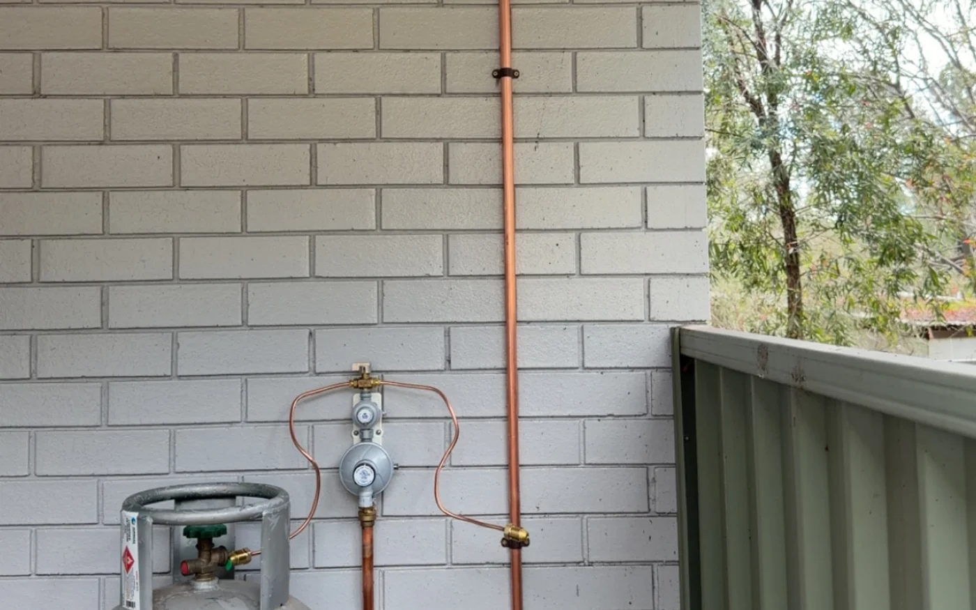 LPG regulator and copper gas pipework installed on a wall