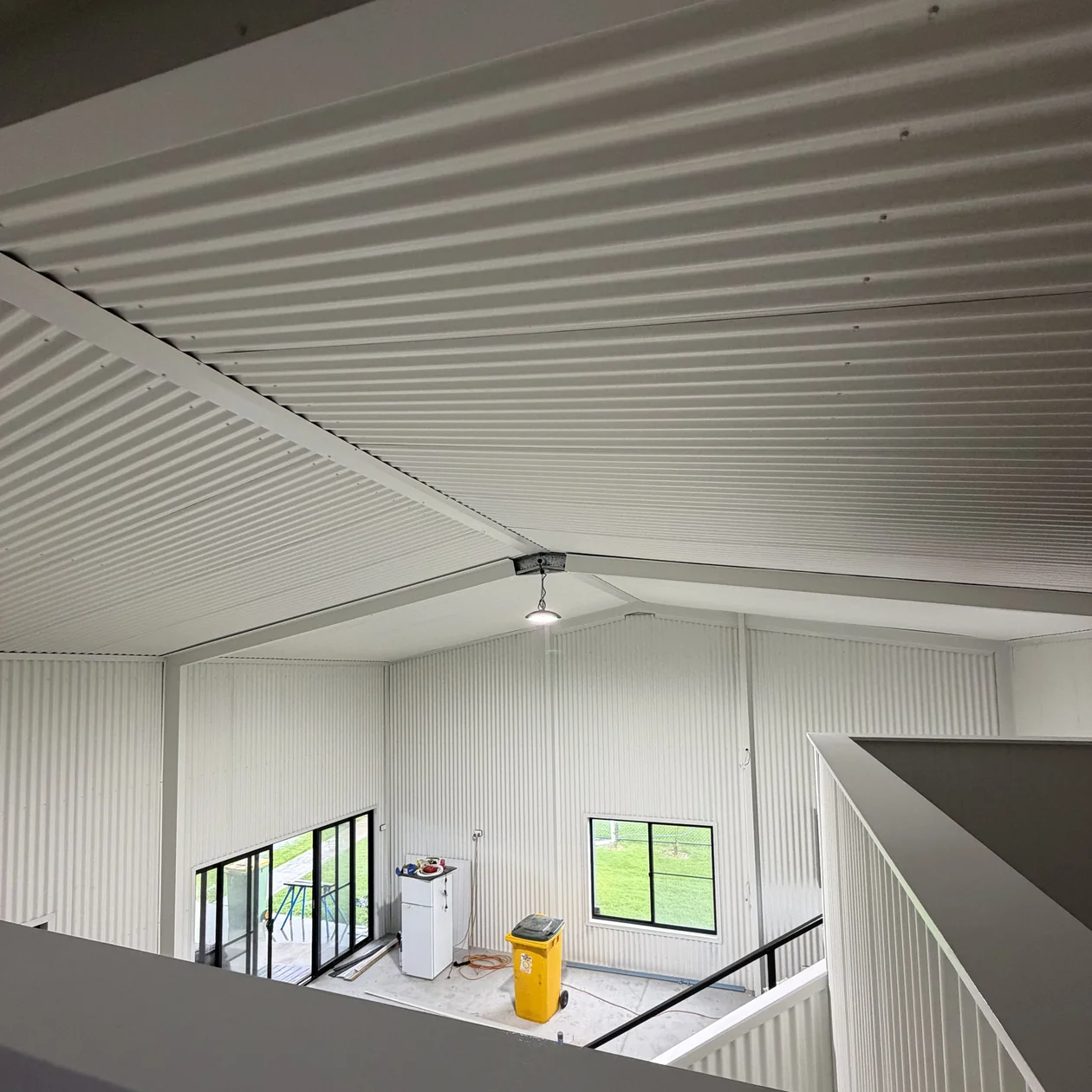 Interior of a metal building showing lined roof and wall sheeting