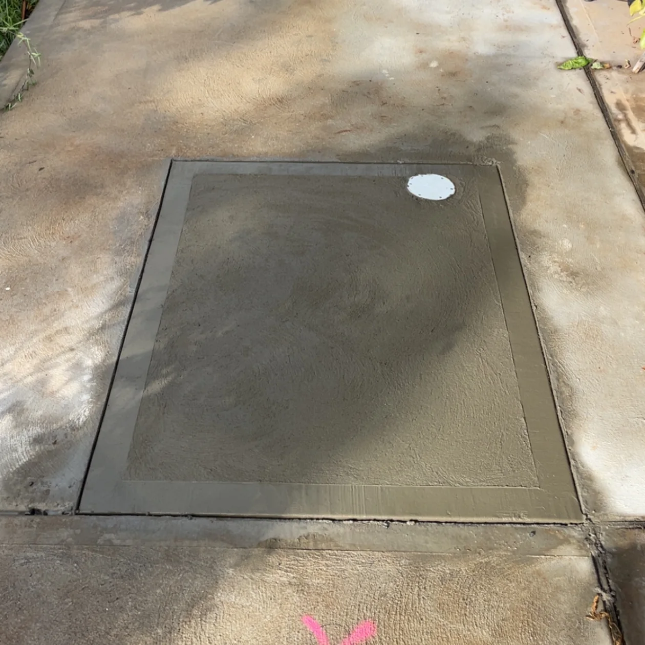 Concrete path neatly reinstated over a new drain connection at a house
