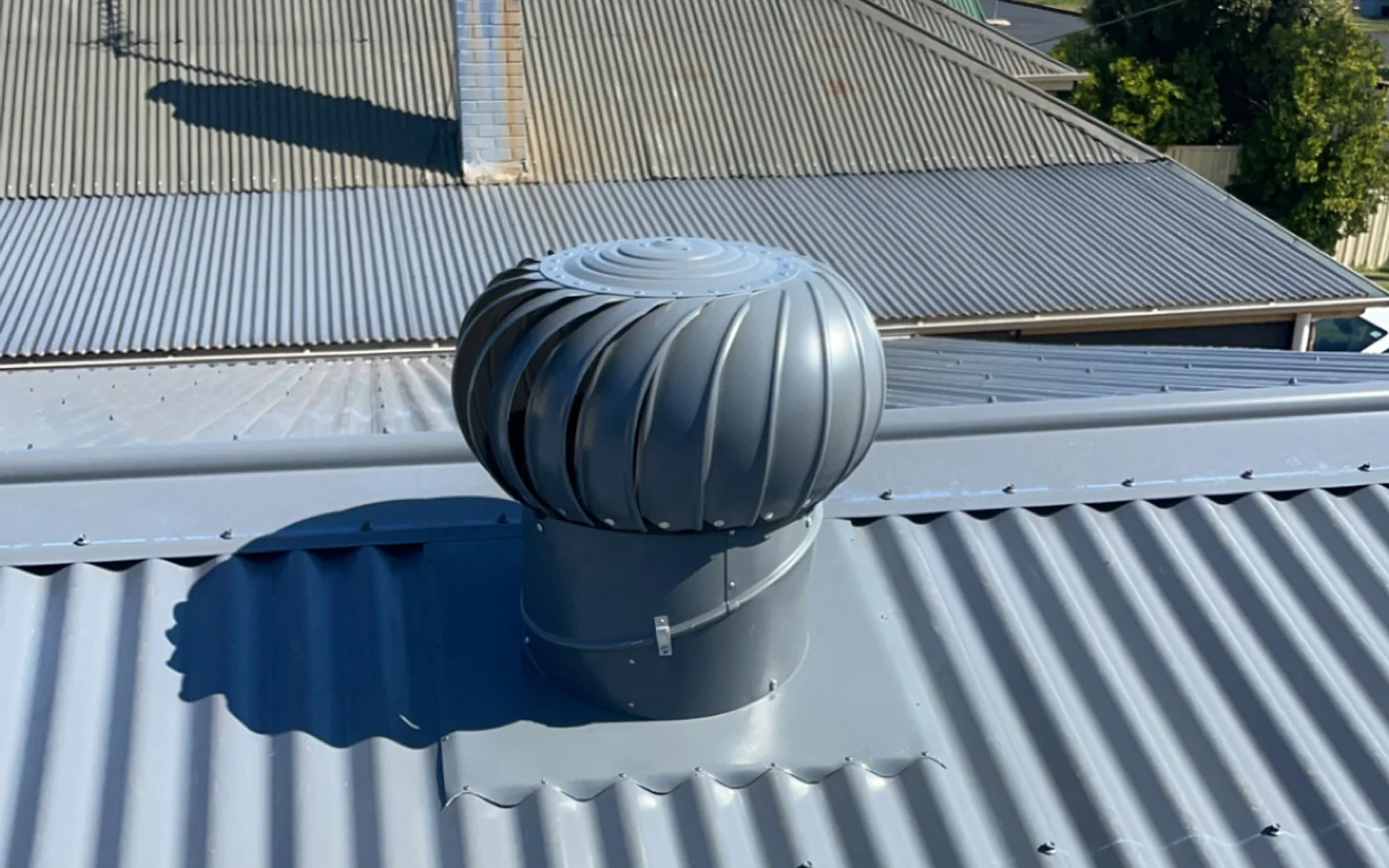 Roof ventilator installed and flashed into a metal roof