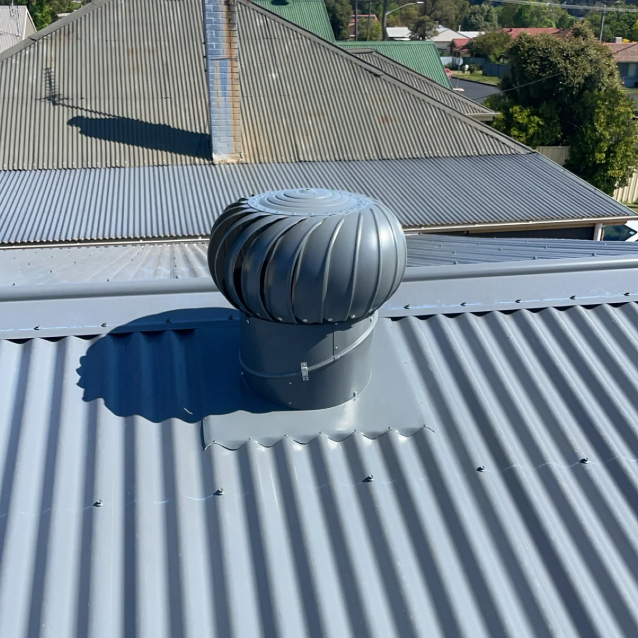 Roof ventilator correctly flashed into metal roof sheeting