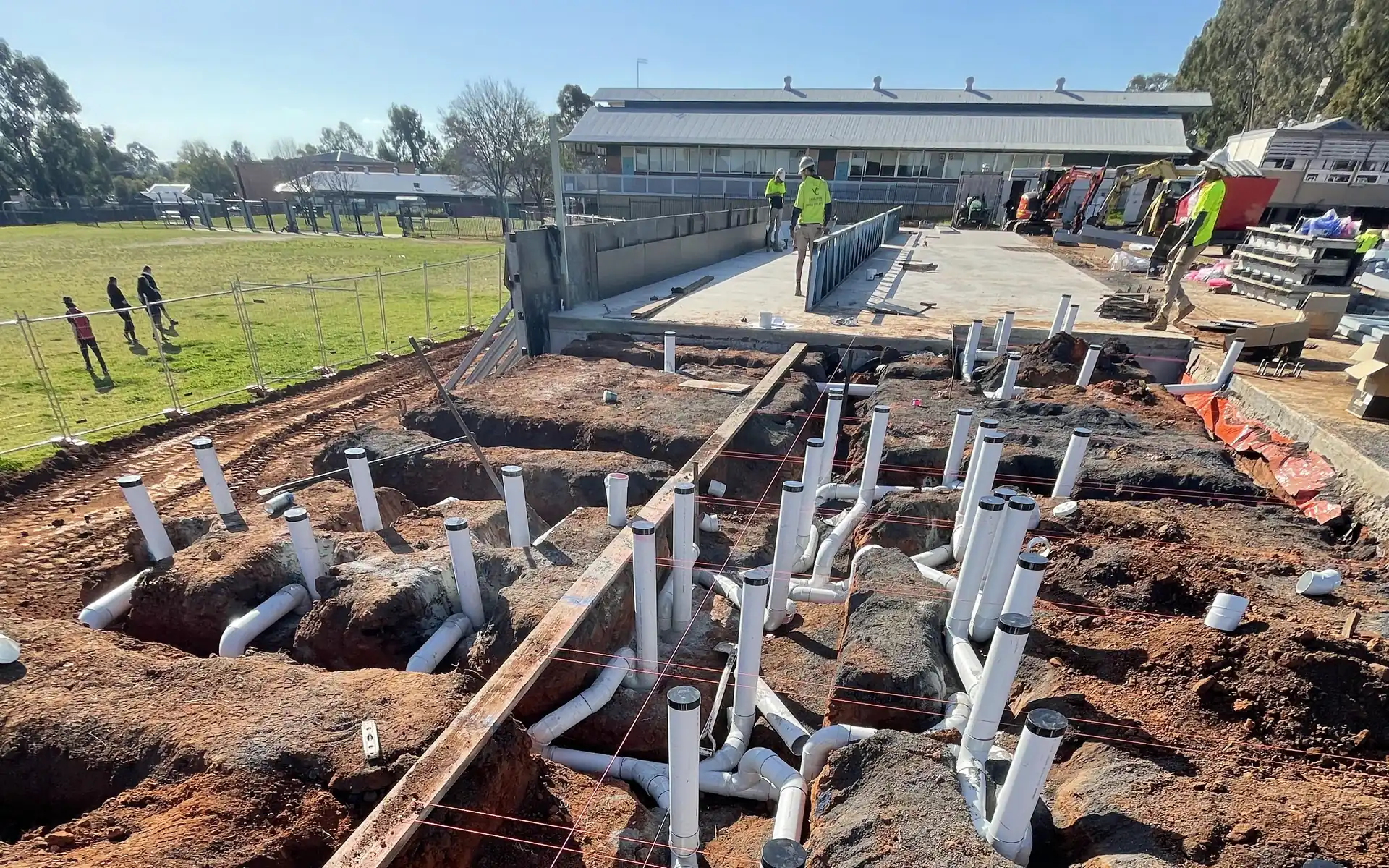 In-ground sanitary drainage roughed in across a large commercial site